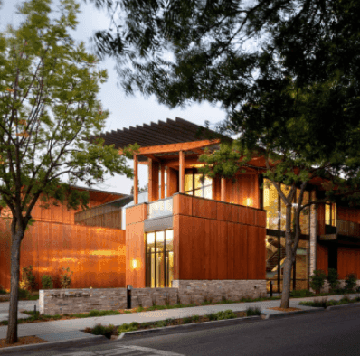 Timber-clad building lit at dusk